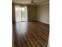 Bright living room featuring wood floors and a sliding door to the balcony at 5681 Bentgrass Dr # 13-201, Sarasota, FL 34235