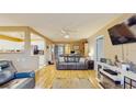 Living room with hardwood floors, a ceiling fan and a view of the kitchen at 6342 7Th W Ave # 6342, Bradenton, FL 34209