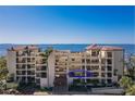 Beautiful condo building with balconies overlooking scenic water views and lush landscaping at 6460 Mourning Dove Dr # 204, Bradenton, FL 34210