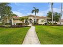 Well-manicured lawn leads to an inviting single-story home with barrel tile roof at 6637 Taeda Dr, Sarasota, FL 34241