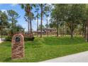 Long driveway leads to home with lush landscaping, offering privacy and beauty at 7401 S Gator Creek Blvd, Sarasota, FL 34241