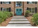 Elegant entryway with double doors, potted plants, and brick facade that adds beauty at 7401 S Gator Creek Blvd, Sarasota, FL 34241