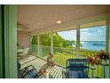 Screened lanai with views of the lush greenery and waterfront for relaxing and entertaining at 749 Manatee Ave, Holmes Beach, FL 34217