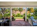 View of the garden from a covered brick patio with outdoor seating at 813 Hudson Ave, Sarasota, FL 34236