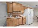 Functional kitchen with bright cabinets, neutral counters, and all-white appliances at 8424 Regal Way, Palmetto, FL 34221