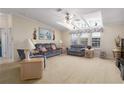 Bright living room with vaulted ceilings, neutral carpet, and comfortable seating for relaxation at 8424 Regal Way, Palmetto, FL 34221