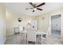 Bright dining room features modern ceiling fan, neutral tones, and a sleek tile floor at 8798 Herbison Ave, North Port, FL 34287