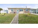 Inviting single-story home with a well-manicured lawn and quaint facade at 8798 Herbison Ave, North Port, FL 34287