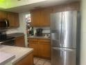 Kitchen featuring stainless steel refrigerator and a pantry at 965 Whitman Dr, Sarasota, FL 34243