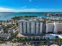Stunning aerial view of the white condo building, marina, and bay with boats on a sunny day at 101 S Gulfstream Ave. # 9C, Sarasota, FL 34236