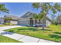 Well-maintained single-Gathering home with a two-car garage, landscaped yard, and welcoming entrance at 11037 77Th E St, Parrish, FL 34219