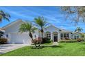Charming home with lush landscaping, a two-car garage, and an inviting front entrance at 1110 93Rd Nw St, Bradenton, FL 34209