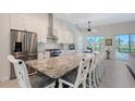 Spacious kitchen featuring modern appliances, a granite island with seating, and a bright breakfast nook at 1110 93Rd Nw St, Bradenton, FL 34209