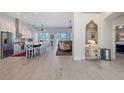 Bright open-concept living and dining area with hardwood flooring and an abundance of natural light at 1110 93Rd Nw St, Bradenton, FL 34209