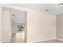 Bright entryway featuring wood flooring with an open view of the dining and living area at 11790 Fennemore Way, Parrish, FL 34219