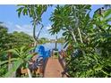 Charming dock with colorful chairs, offering a peaceful waterfront retreat amidst lush foliage at 1248 Jefferson Dr, Englewood, FL 34224