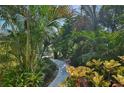 A serene landscaped path winds through lush greenery, creating a private and inviting entrance at 1248 Jefferson Dr, Englewood, FL 34224