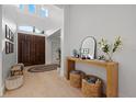 Bright foyer featuring a wooden door, light wood floors, and a console table with decorative items at 125 12Th E Ave, Palmetto, FL 34221