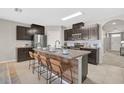 Spacious kitchen features stainless steel appliances and a large center island with seating at 15408 Trinity Fall Way, Bradenton, FL 34212