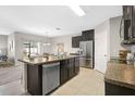 Modern kitchen with a large island, stainless steel appliances, and ample counter space at 15408 Trinity Fall Way, Bradenton, FL 34212