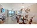 Cozy living room/dining room area with sliding doors and golf course view at 17510 Gawthrop Dr # 305, Bradenton, FL 34211