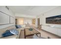 Comfortable living room and dining area with neutral tones, modern decor, and bright, airy feel at 1800 Benjamin Franklin Dr # B308, Sarasota, FL 34236