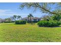 Inviting home with a well-manicured lawn and lush landscaping creating a picturesque curb appeal at 22354 Panther Loop, Bradenton, FL 34202