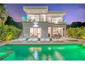 Modern home featuring a pool with lounge chairs and multiple balconies, perfect for outdoor relaxation at 2327 Hillview St, Sarasota, FL 34239