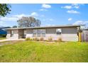 Charming single-story home with fresh exterior paint and a well-maintained lawn and beautiful landscape at 2361 Rose St, Sarasota, FL 34239