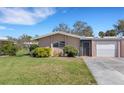 Inviting single-story home with a well-kept lawn and convenient attached garage at 3140 Village Green Dr # 1119, Sarasota, FL 34239