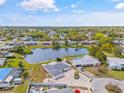 Scenic aerial view of community featuring a serene pond, well-maintained yards, and charming homes at 3611 22Nd W Ave, Bradenton, FL 34205
