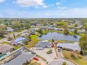 Aerial view of neighborhood showcasing a beautiful pond and landscaped yards at 3611 22Nd W Ave, Bradenton, FL 34205