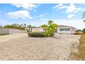 Inviting single-story home with lush landscaping, a circular driveway, and a two car garage at 3611 22Nd W Ave, Bradenton, FL 34205