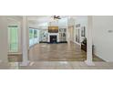 Spacious living room featuring a fireplace, wood floors, and glass sliding doors to outdoor space at 3704 Prairie Dunes Dr, Sarasota, FL 34238