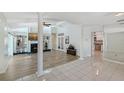 Elegant living room with fireplace, wood floors, columns and view into the kitchen at 3704 Prairie Dunes Dr, Sarasota, FL 34238