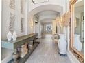 Inviting foyer with high ceilings, decorative mirror, stylish console table, and elegant chandelier at 3707 5Th Ne Ave, Bradenton, FL 34208