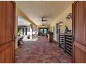 Covered outdoor living space featuring brick flooring, ceiling fans, and an inviting ambiance at 402 Walls Way, Osprey, FL 34229