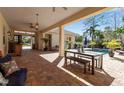 Inviting outdoor patio features brick pavers, a dining area, and a view of the pool surrounded by lush landscaping at 402 Walls Way, Osprey, FL 34229