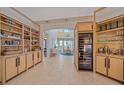 Elegant dining area with built-in shelves, a wine refrigerator, and a view to the backyard at 4510 Murcia Blvd # 16, Sarasota, FL 34238