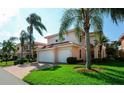 Charming two-story home with a paver driveway, a tile roof, and tropical landscaping at 4510 Murcia Blvd # 16, Sarasota, FL 34238