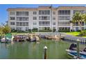 Waterfront condo building with private docks and lush landscaping along the water's edge at 600 Sutton Pl # 104, Longboat Key, FL 34228