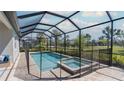 Screened-in pool area with a relaxing pool and attached spa at 6172 Lungo Lago Dr, Sarasota, FL 34241