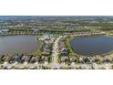 An aerial view of a beautiful home located between two ponds in a gated community at 6410 Rosehill Farm Run, Bradenton, FL 34211