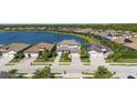 An aerial view of a beautiful two-story home with a tile roof, landscaping and lake view at 6410 Rosehill Farm Run, Bradenton, FL 34211