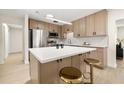 Modern kitchen featuring stainless steel appliances, an island, and sleek wood-tone cabinetry at 6639 16Th N St, St Petersburg, FL 33702