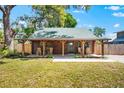 Charming log cabin with inviting front porch, and rocking chairs perfect for relaxing at 6811 6Th W St, Bradenton, FL 34207