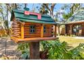 Unique log cabin style mailbox adding a touch of rustic charm to the home's exterior at 6811 6Th W St, Bradenton, FL 34207