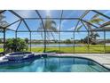 Relaxing screened pool area with an attached spa and beautiful lake views at 6915 Honeysuckle Trl, Lakewood Ranch, FL 34202