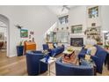Bright living room with high ceilings, a fireplace, and comfortable blue furnishings at 7713 Fairway Woods Dr # 902, Sarasota, FL 34238