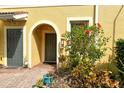 Charming front entrance with well-maintained landscaping and welcoming arched entryway at 7979 Limestone Ln # 14-101, Sarasota, FL 34233